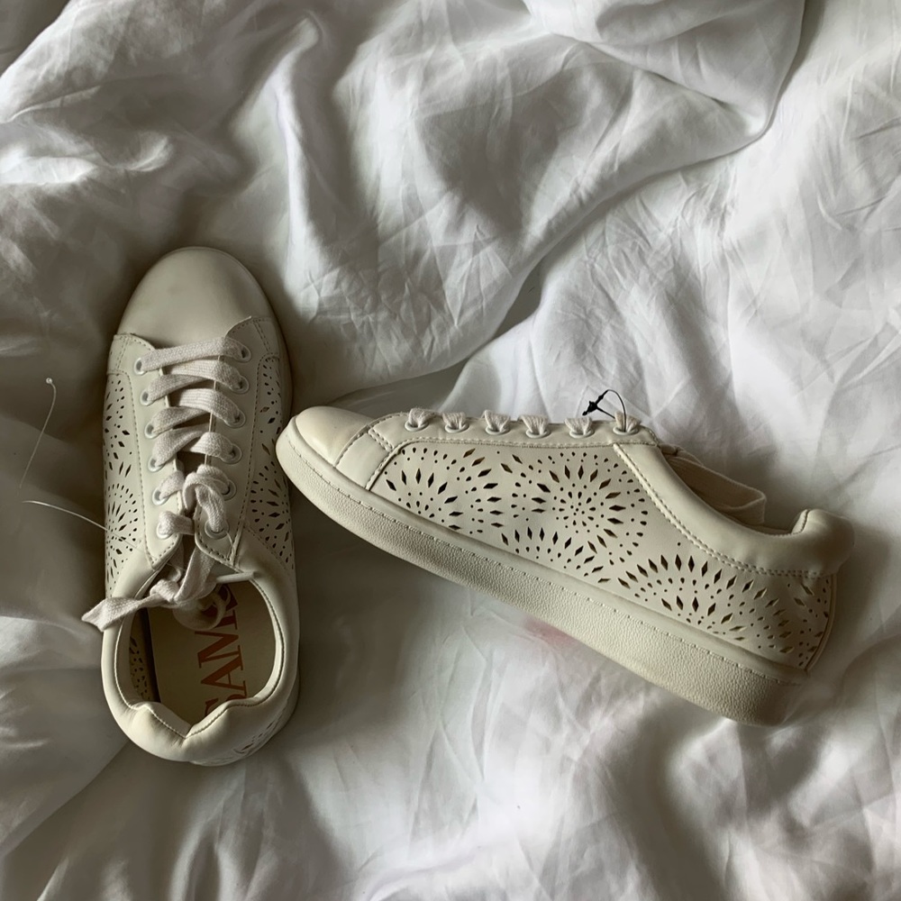 white shoes with floral cutouts
